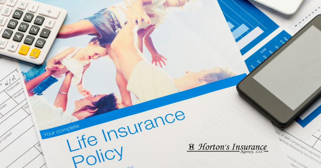 A complete Life Insurance Policy document from Horton's Insurance Agency layered over financial charts with a calculator and smartphone